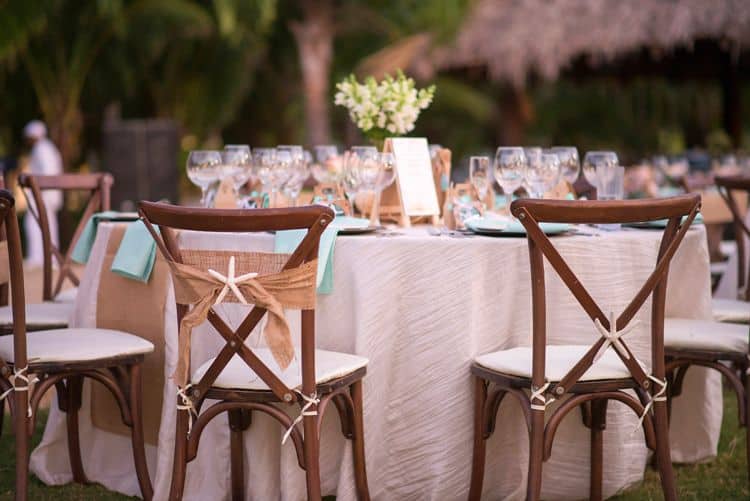 beach themed wedding chairs with burlap sash and starfish detail