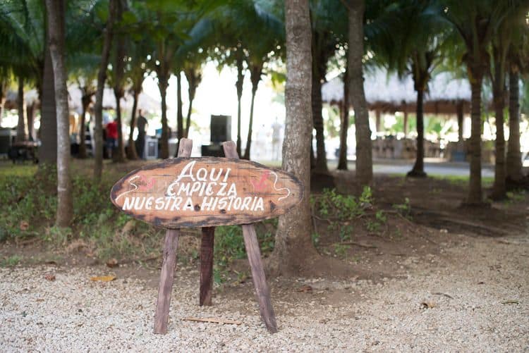 Wood wedding sign that reads "Our Story Starts Here"