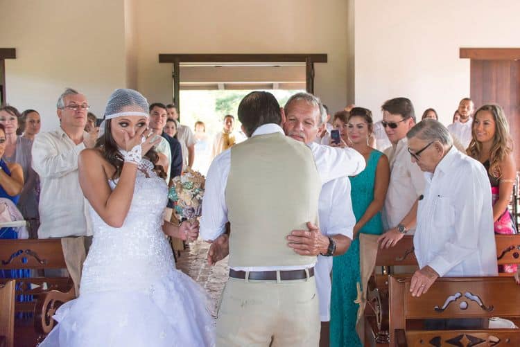 The father of the bride hugging the groom