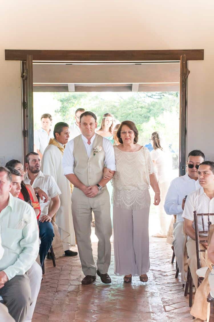 groom walking into chapel with his mother