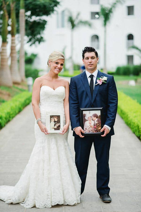 newlyweds holding photo of their parent's weddings