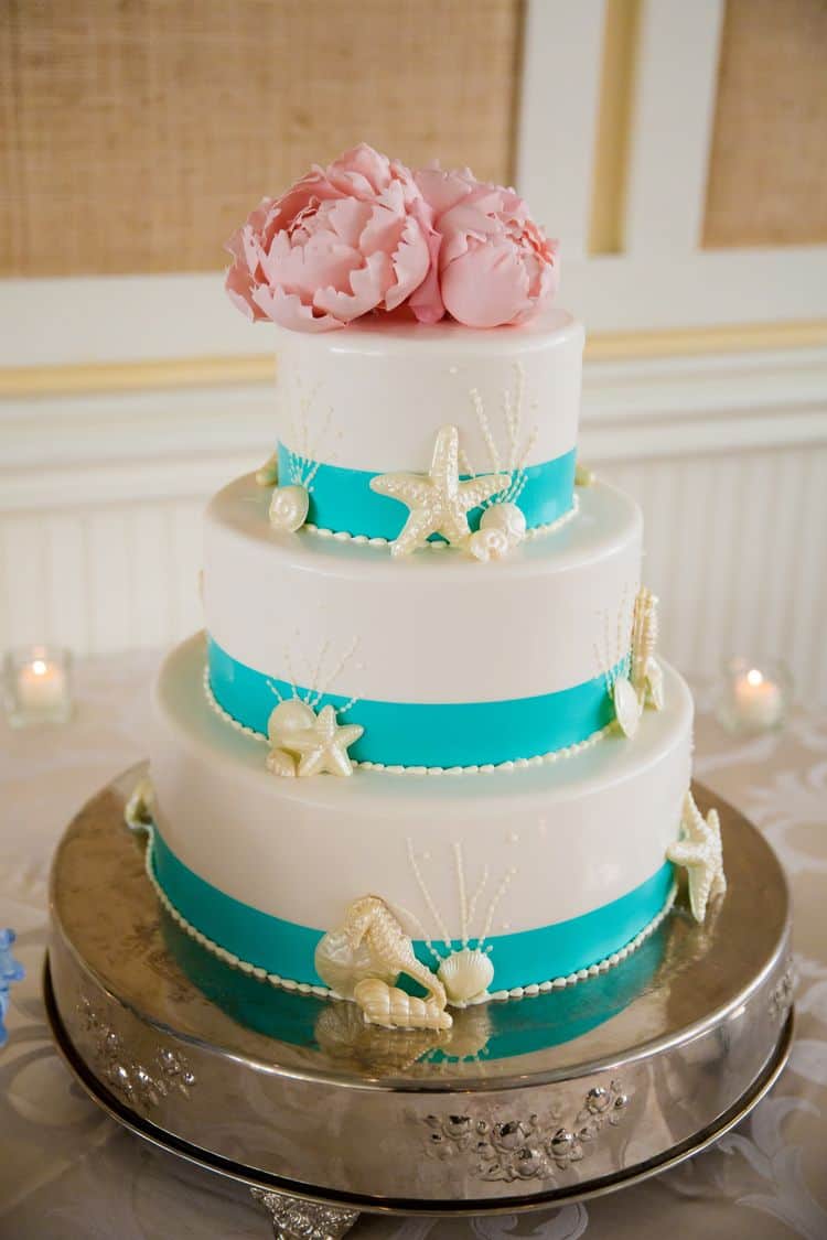 Gorgeous beach wedding cake in white and aqua with pink flowers