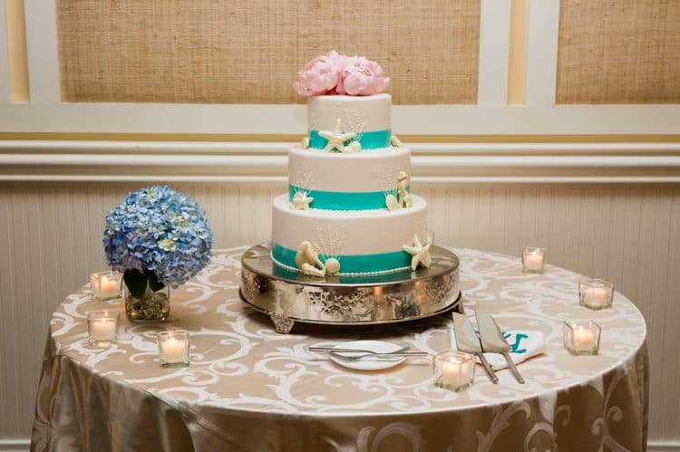 Gorgeous beach wedding cake in white and aqua with pink flowers