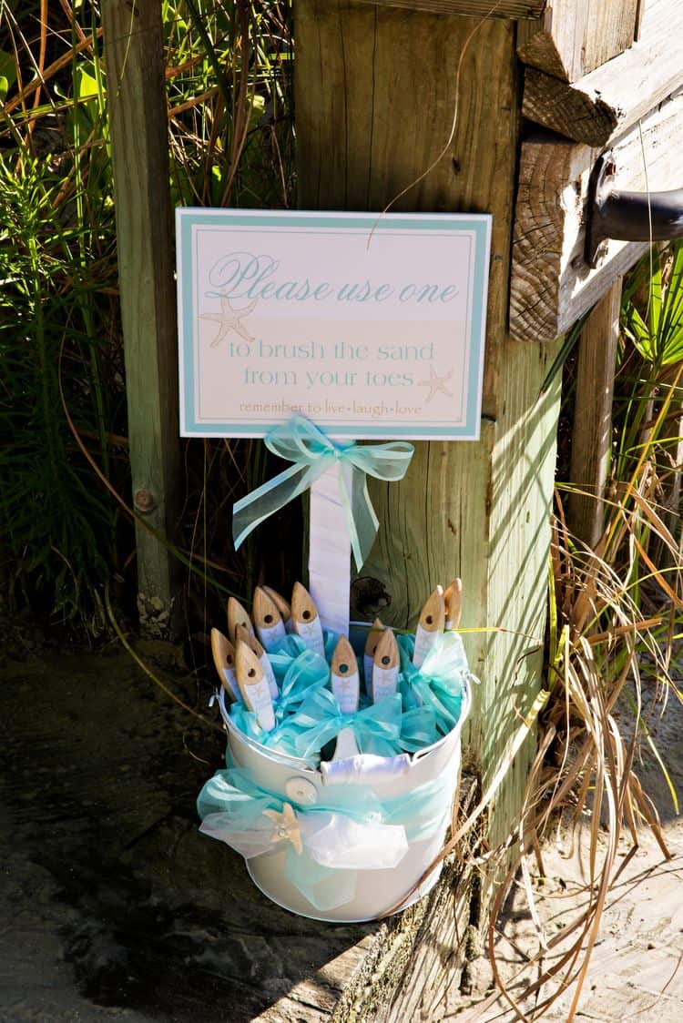 Brushes to remove sand from feet at a beach wedding