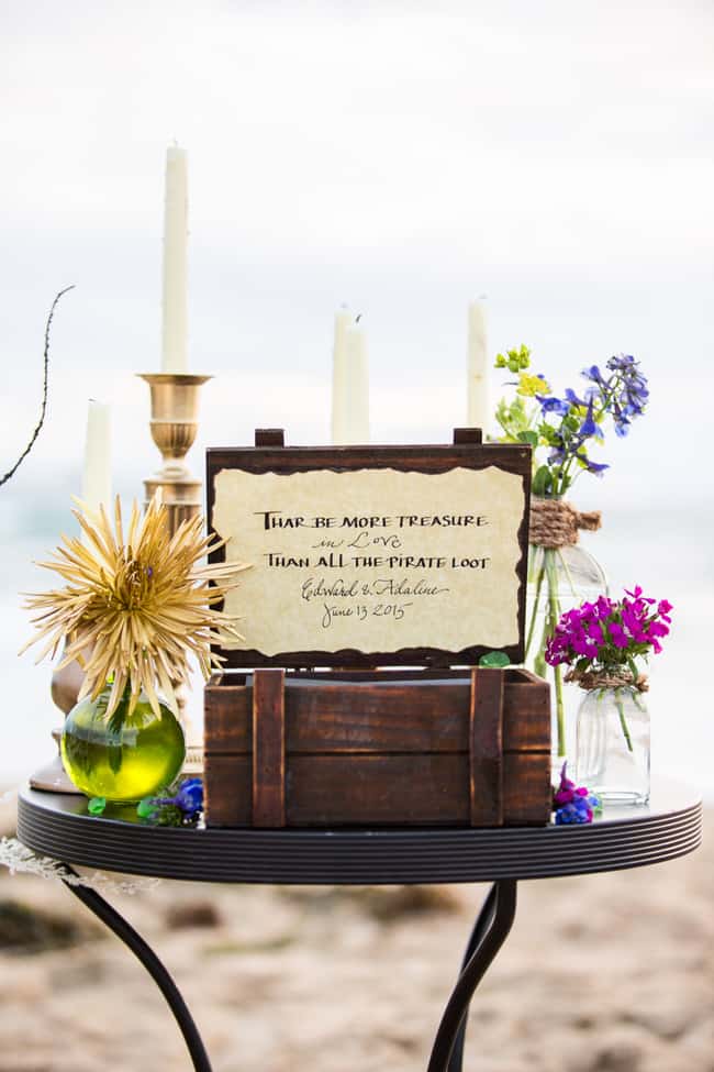 Unique beach wedding decor - treasure chest, candelabras and jewel toned flowers