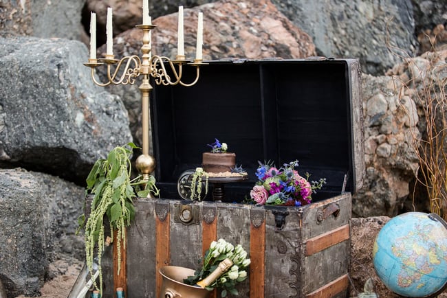 Shipwrecked beach wedding inspiration with treasure chests, candelabras, message in a bottle and jewel toned flowers