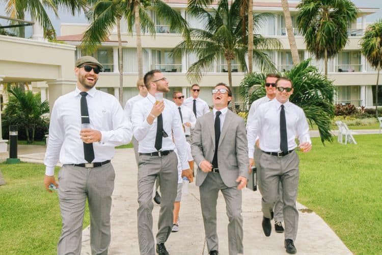 Destination wedding groomsmen wearing gray attire