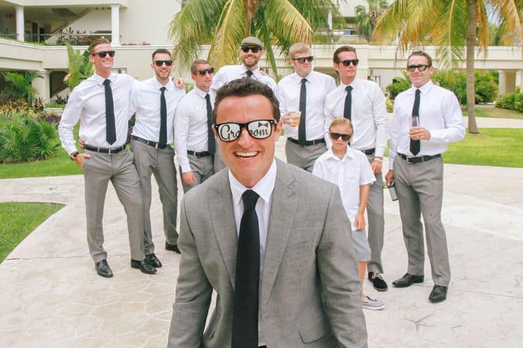 The groom wearing fun sunglasses