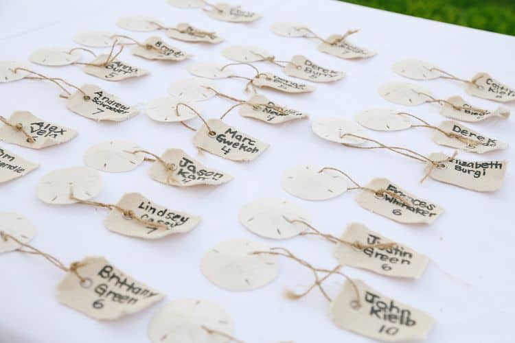 destination wedding seating cards made with sand dollars and luggage tags