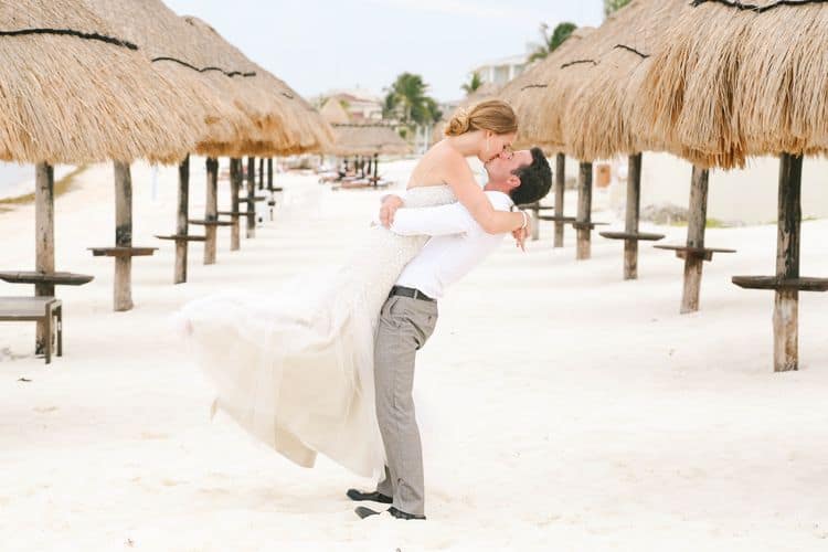 Cancun wedding photo with palapas on the beach