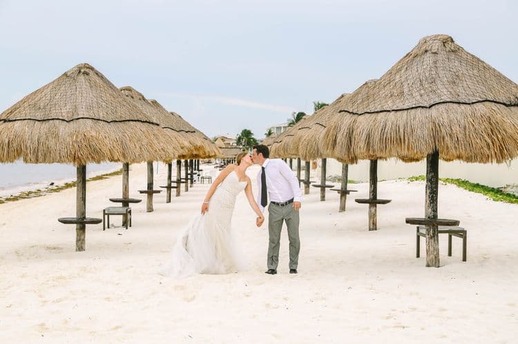 Cancun wedding photo with palapas on the beach