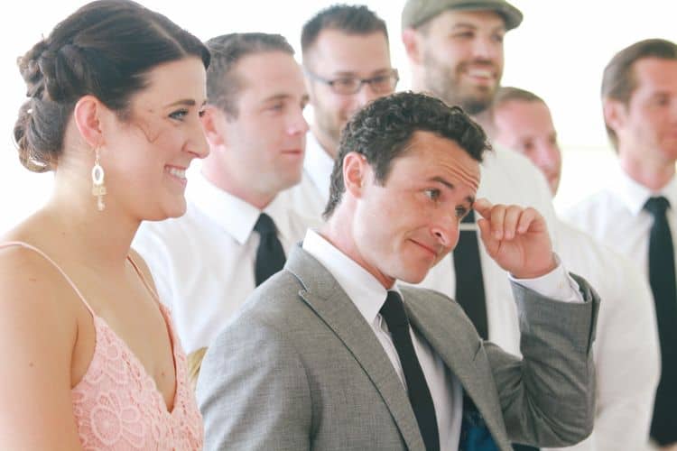 The groom watching the bride walk down the aisle