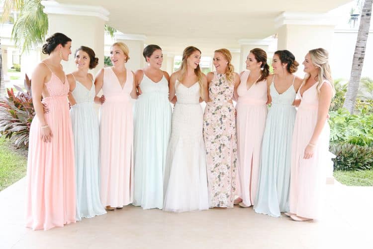 Beach bridesmaids wearing mismatched pastel dresses